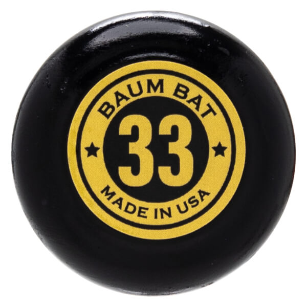 Close-up of a black baseball bat knob with a yellow circular label showing "BAUM BAT 33 MADE IN USA".