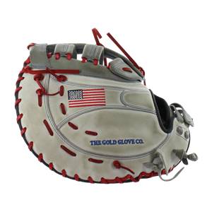 Side view of a gray first base mitt with red lacing, an American flag patch, and THE GOLD GLOVE CO. text.