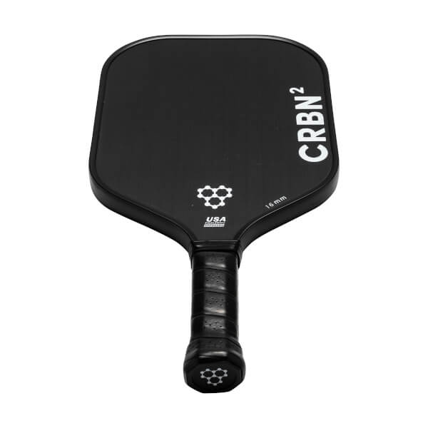 Top-down view of a black pickleball paddle with CRBN² branding, a honeycomb logo, and a textured grip.
