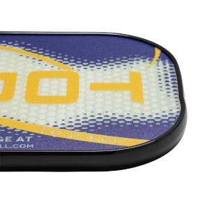 Corner view of a blue and white pickleball paddle with yellow text and a black edge.