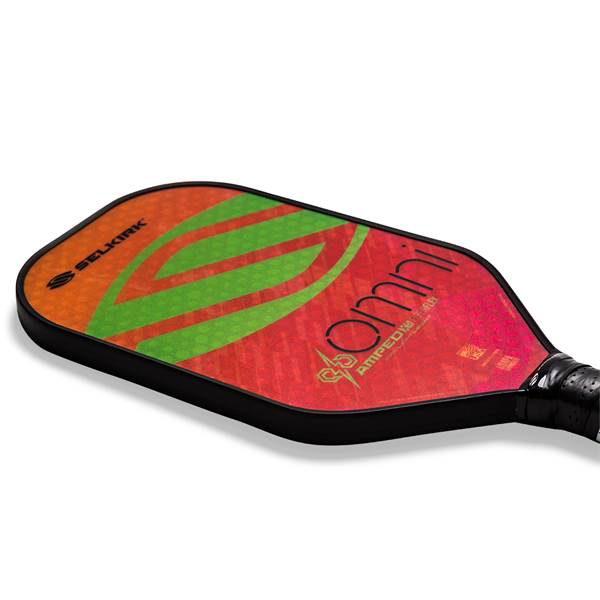 Top-down view of a red pickleball paddle with green stripes and OMNI text.
