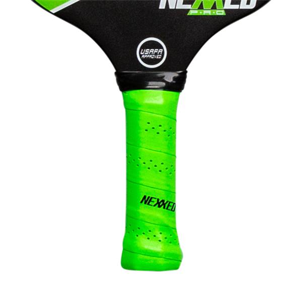 Close-up of a bright green pickleball paddle grip with perforations and the NEXXED logo.