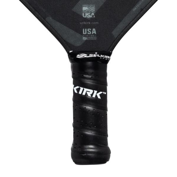 Close-up of a black pickleball paddle grip with KIRK branding and SELKIRK logo.