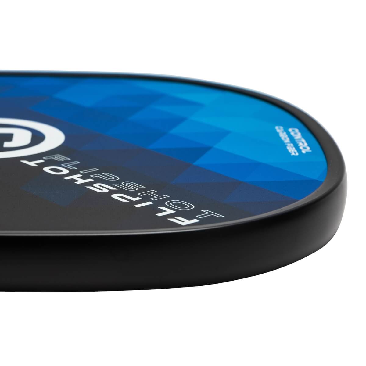 Corner view of a black pickleball paddle with blue geometric design, FLIPSHOT text, and CONTROL CARBON FIBER text.