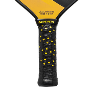 Close-up of a black pickleball paddle grip with yellow honeycomb pattern and GAMMA logo.