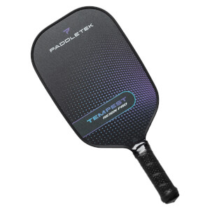 Top-down view of a black pickleball paddle with PADDLETEK and TEMPEST REIGN PRO text and a gradient dot pattern.