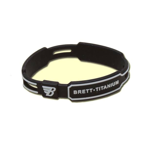 Close-up of a black bracelet with white B logo and BRETT•TITANIUM text.