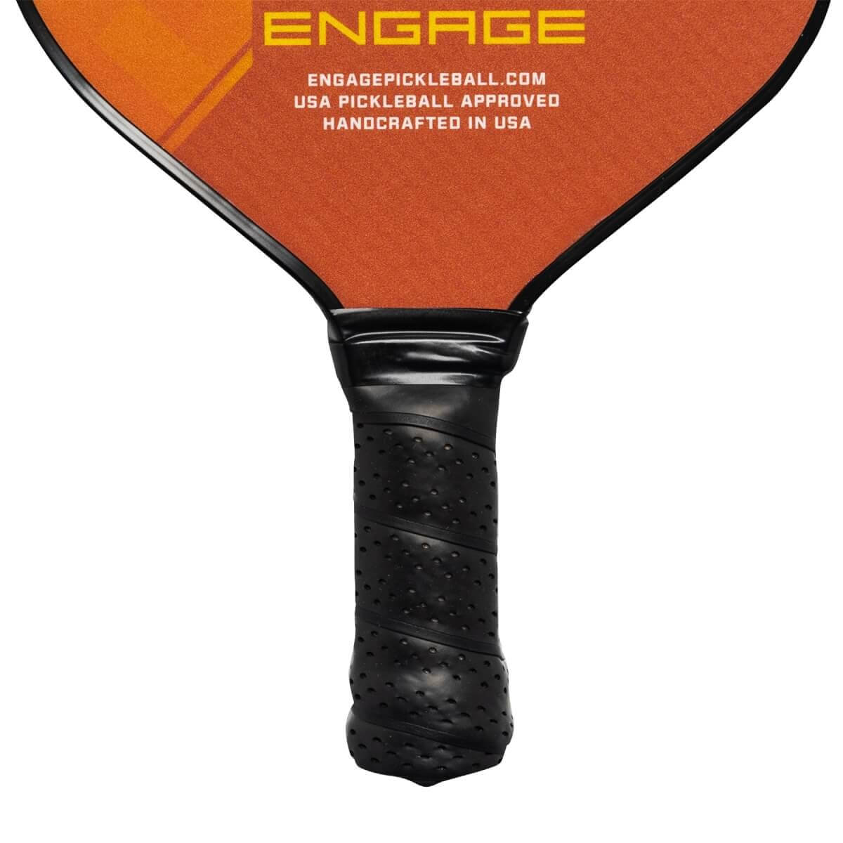 Close-up of a black pickleball paddle grip with perforated texture and the Engage logo.
