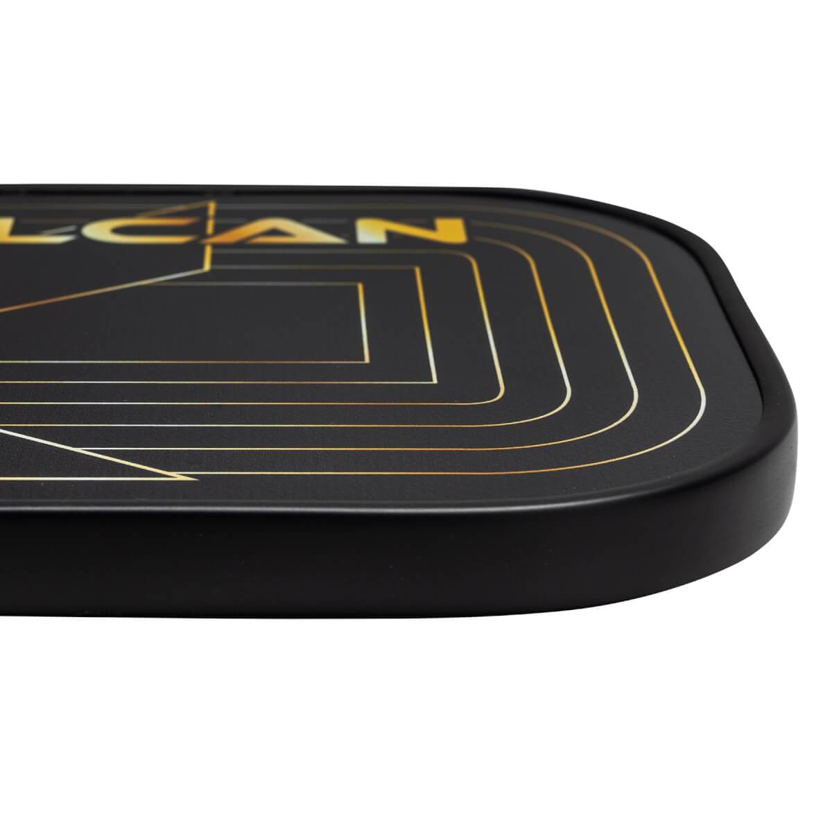 Corner view of a black pickleball paddle with gold geometric lines and LCAN text.