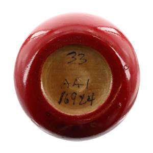 Bottom view of a red baseball bat with 33, AA1, and 16924 written on the end.