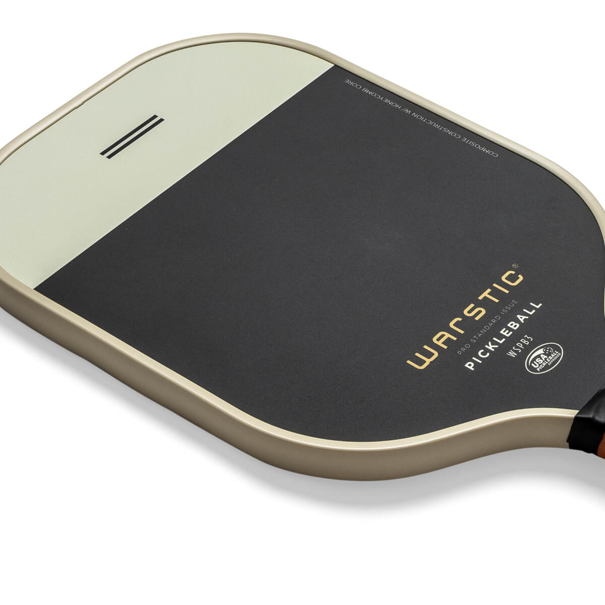 Top-down view of a black and cream pickleball paddle with Warstic branding and USA Pickleball logo.