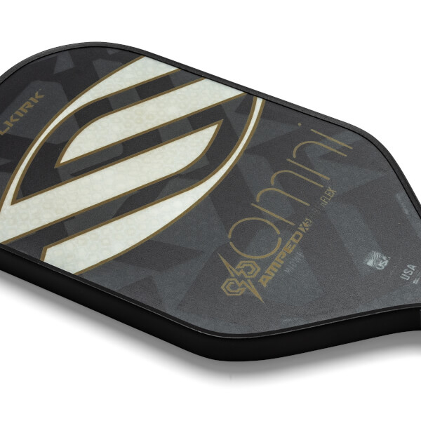 Top-down view of a black pickleball paddle with a large white and gold S graphic and omni text.
