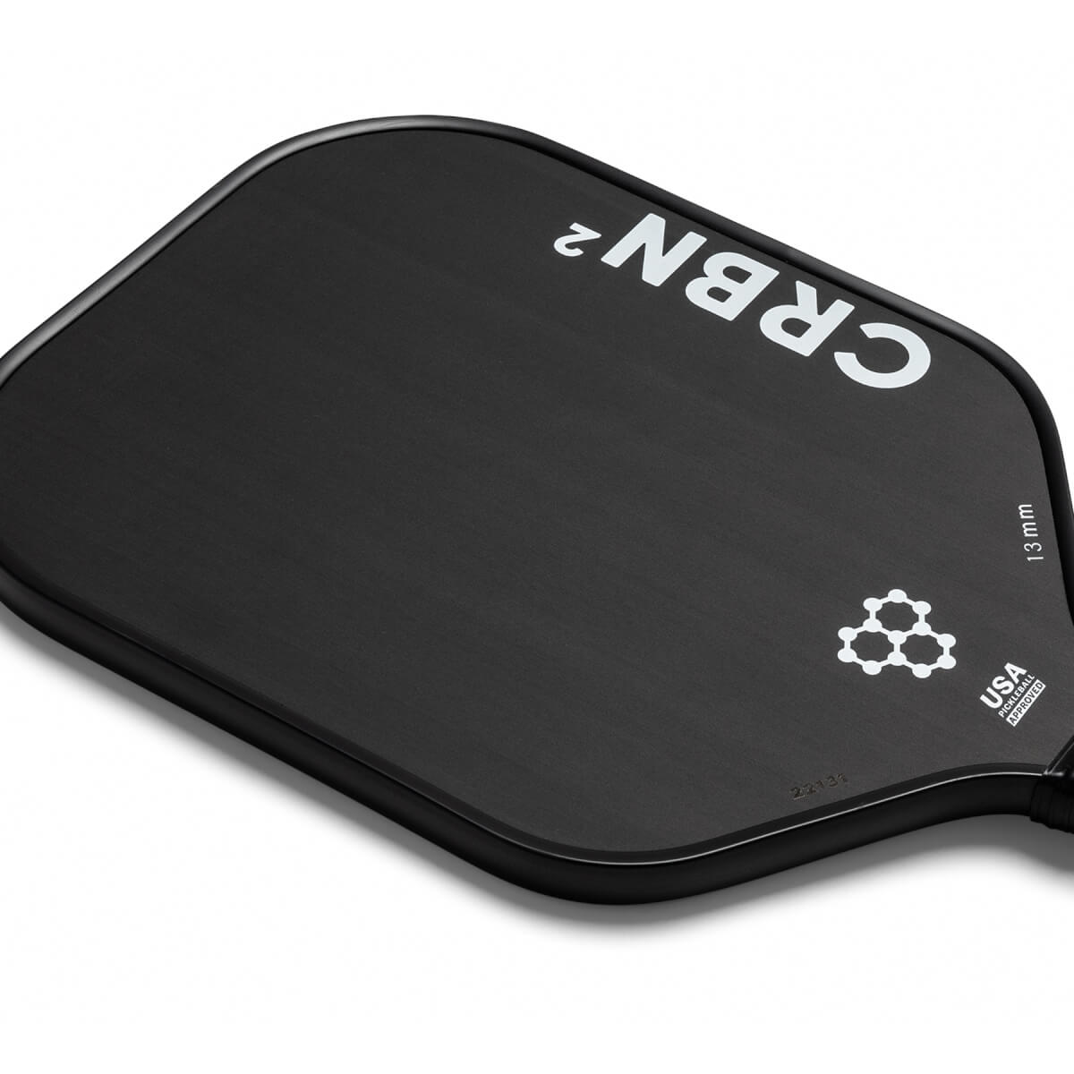 Top-down view of a black pickleball paddle with white CRBN² branding, a honeycomb logo, and 13 mm USA Pickleball Approved text.