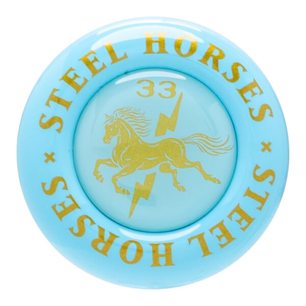 Top-down view of a light blue circular object with gold lettering "STEEL HORSES" and a gold horse and lightning bolt graphic.