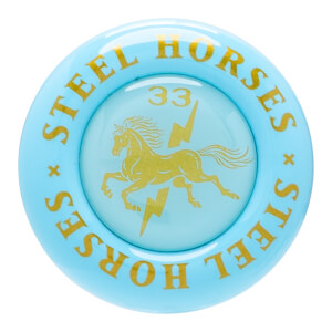 Top-down view of a light blue circular object with gold lettering "STEEL HORSES" and a gold horse and lightning bolt graphic.