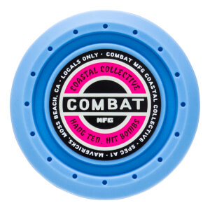 Top-down view of a blue circular product with "COMBAT" in large white letters on a pink and black label.
