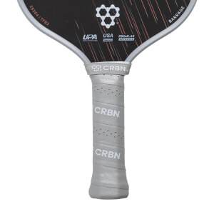 Close-up of a black and grey pickleball paddle with a perforated grey grip and CRBN and BARRAGE text.