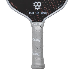 Close-up of a black CRBN pickleball paddle with a grey perforated grip featuring CRBN logos and BARRAGE text.
