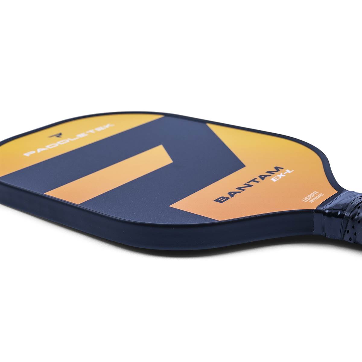 Side view of a navy and orange pickleball paddle with BANTAM EX-L text and a black grip.