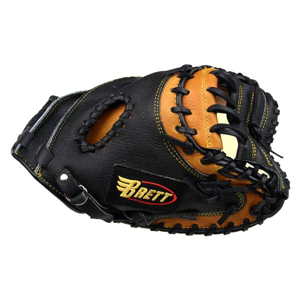 Top-down view of a black and tan catchers mitt with yellow stitching and a Brett logo.