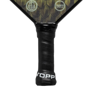 Close-up of a black pickleball paddle grip with white TOPP branding and USAPA Approved and Made in USA logos on the head.
