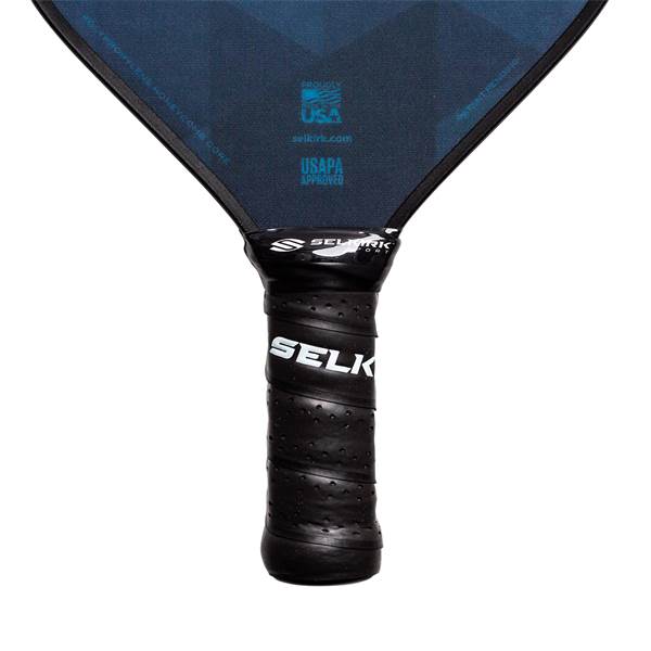 Close-up of a black pickleball paddle grip with SELK branding and textured surface.