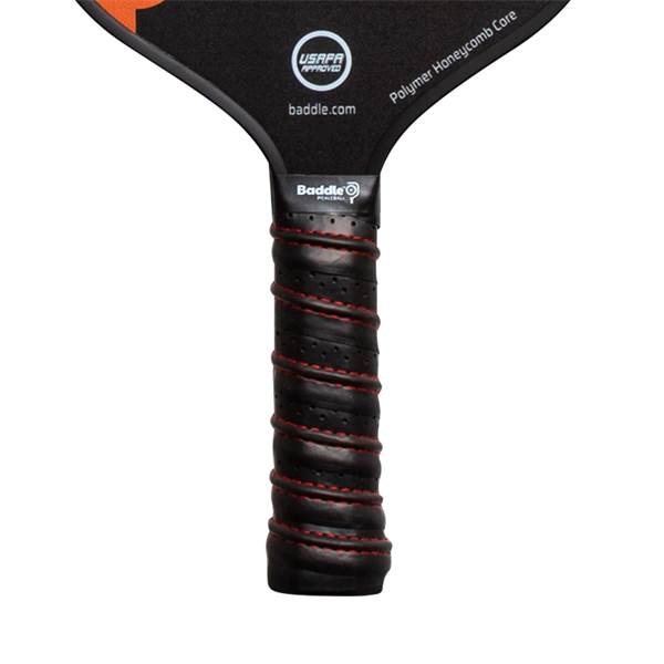 Close-up of a black pickleball paddle grip with red stitching and a Baddle logo.