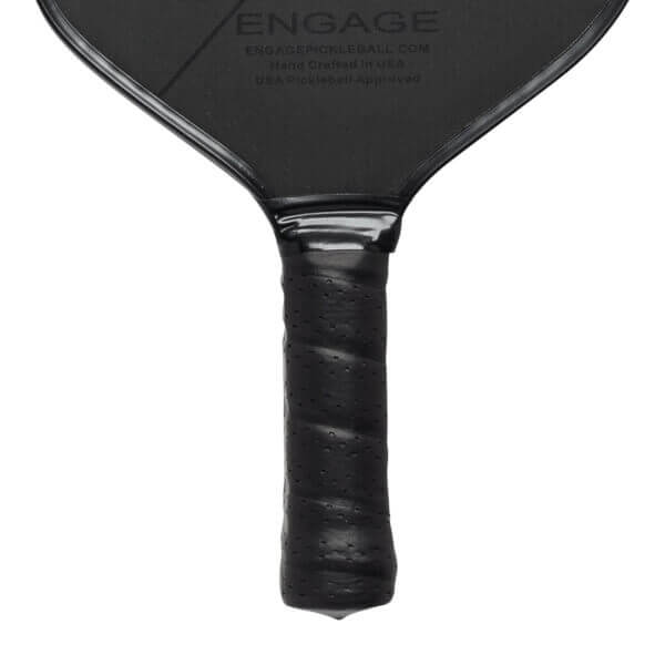 Close-up of a black pickleball paddle grip with perforated texture and ENGAGE text on the paddle face.