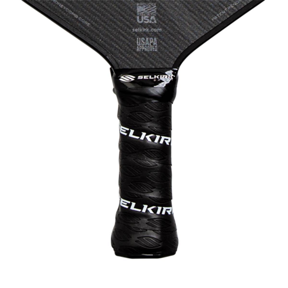 Close-up of a black pickleball paddle grip with white ELKIR branding and a textured surface.