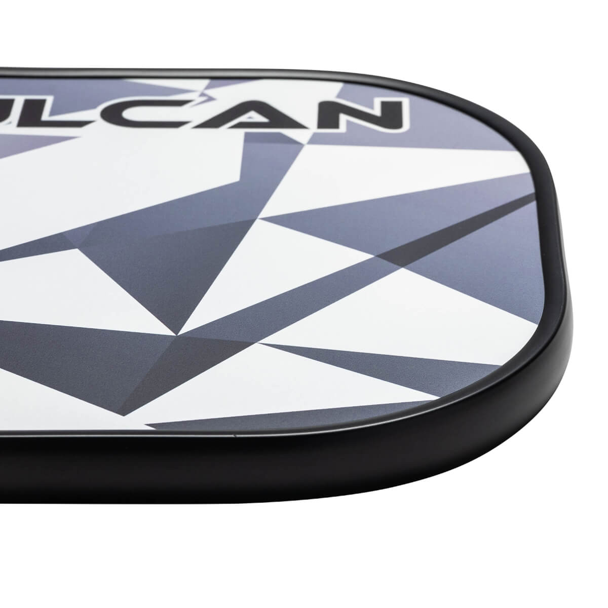 Corner view of a white and black pickleball paddle with a geometric pattern and ULCAN text.