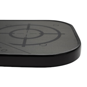 Corner view of a black pickleball paddle with a textured surface and target graphic.
