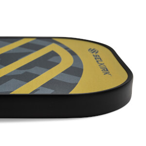 Side view of a yellow pickleball paddle with a black edge and Selkirk logo.