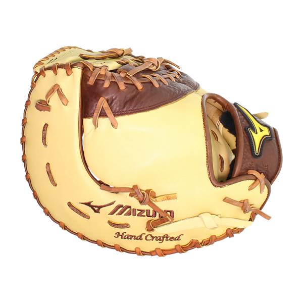 Side view of a tan and brown baseball glove with Mizuno and Hand Crafted text.