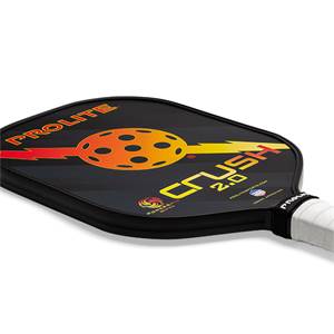 Corner view of a black pickleball paddle with PROLITE and CRUSH 2.0 text, and a circular orange and yellow graphic.