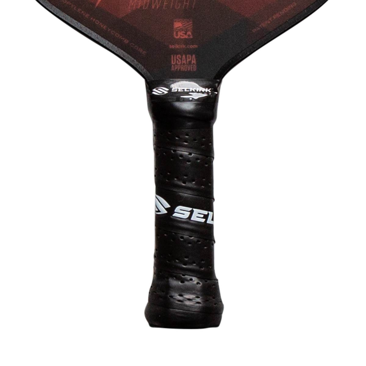 Close-up of a black pickleball paddle grip with a textured surface and white Selkirk branding.
