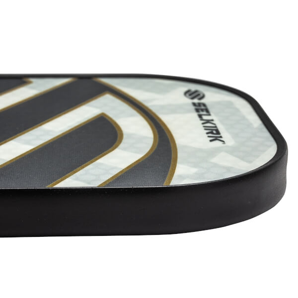 Side view of a white pickleball paddle with black and gold accents and Selkirk branding.