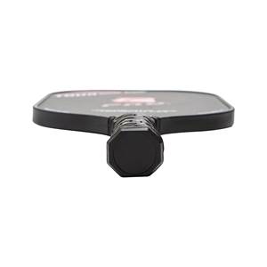 Bottom view of a black pickleball paddle with an octagonal grip and textured surface.