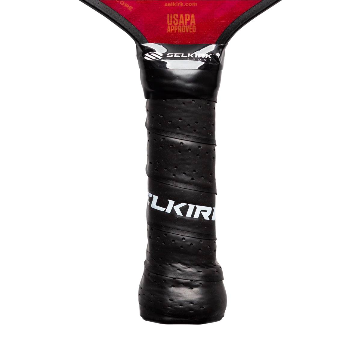 Close-up of a black pickleball paddle grip with white SELKIRK text and USAPA approved label.