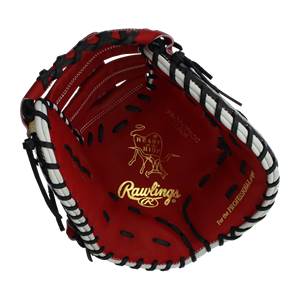 Interior view of a red Rawlings first base mitt with gold Heart of the Hide logo and white lacing.