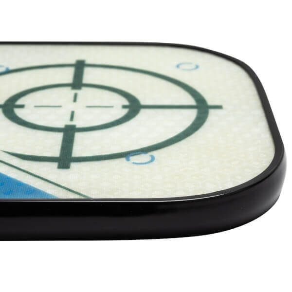 Corner view of a white pickleball paddle with a green target design and black edge.