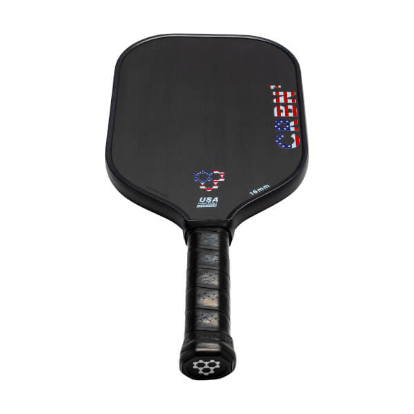 Front view of a black pickleball paddle with CRBN text and USA flag graphic.