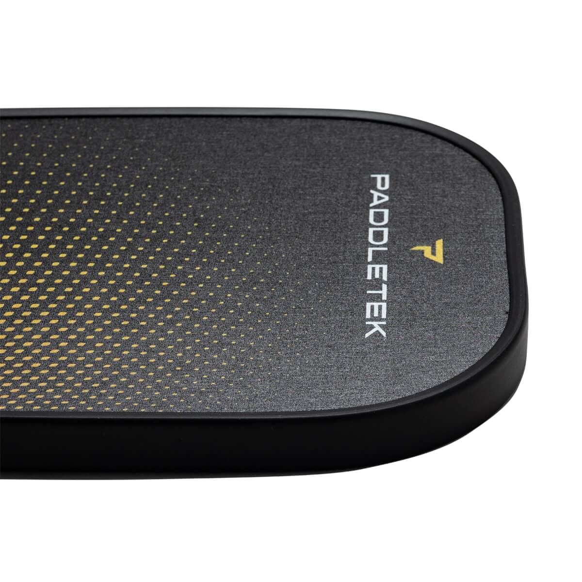 Corner view of a black pickleball paddle with a yellow dotted gradient and PADDLETEK text.