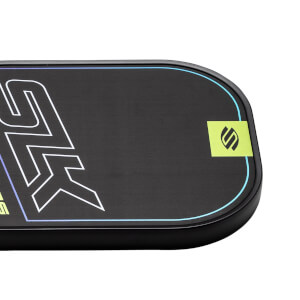 Corner view of a black pickleball paddle with white and blue graphic accents and a green SLK logo.