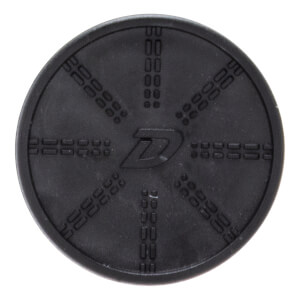 Top-down view of a circular black rubber disc featuring a stylized "D" in the center surrounded by eight radial patterns of embossed dashed lines.