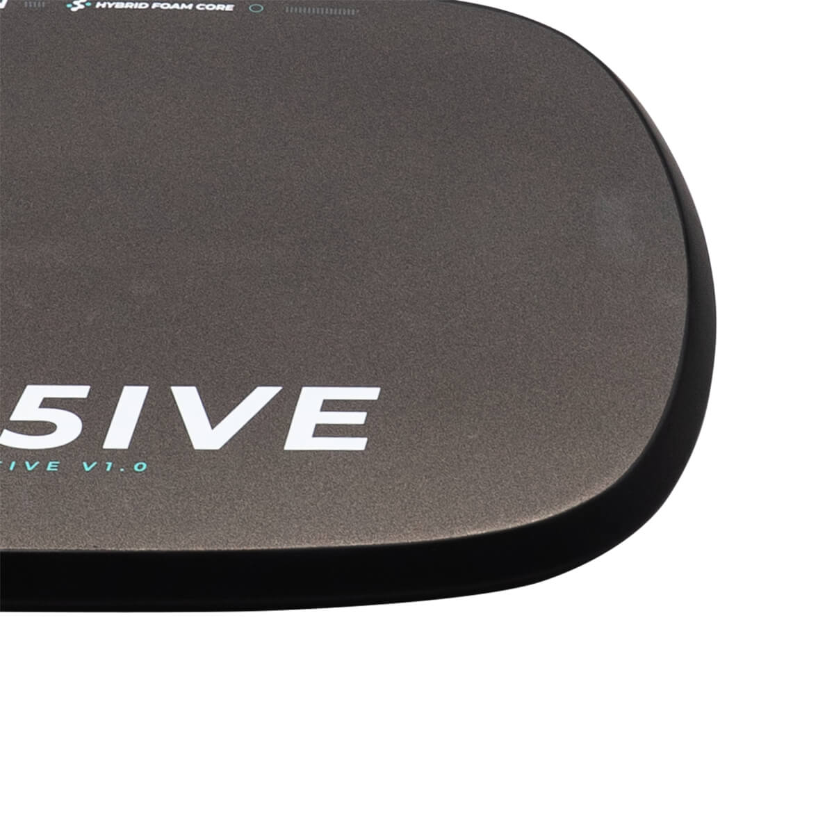 Close-up top-down view of a dark grey paddle corner showing its matte textured surface and the words "5IVE" and "HYBRID FOAM CORE" in white and light blue.