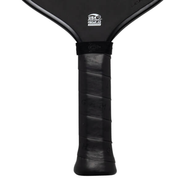 Close-up of the black paddle handle and lower face, featuring a white USA PICKLEBALL PBCoR.43 APPROVED logo and textured black grip tape.