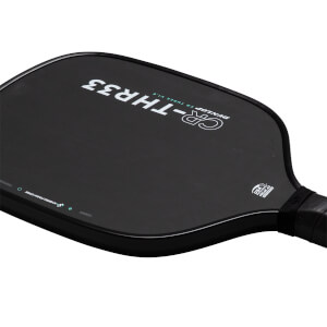 Angled close-up of a black pickleball paddle face featuring "CR-THR33" and "DUNLOP CR THREE V1.0" text alongside a "USA PICKLEBALL APPROVED" seal near the handle.