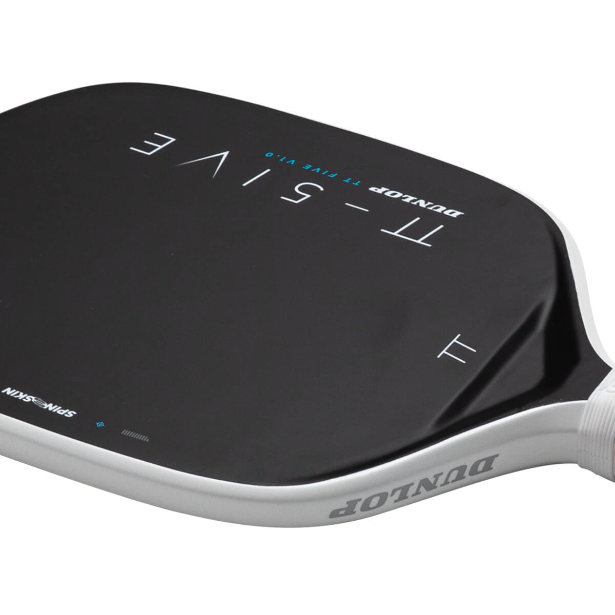 Angled close-up view of a black Dunlop TT-FIVE pickleball paddle featuring a white edge guard with the Dunlop logo and "SPINSKIN" text on the paddle face.