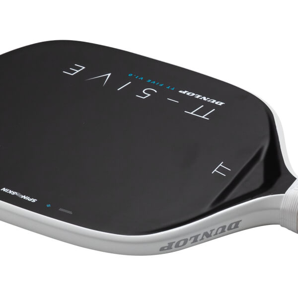 Angled close-up view of a black Dunlop TT-FIVE pickleball paddle featuring a white edge guard with the Dunlop logo and "SPINSKIN" text on the paddle face.