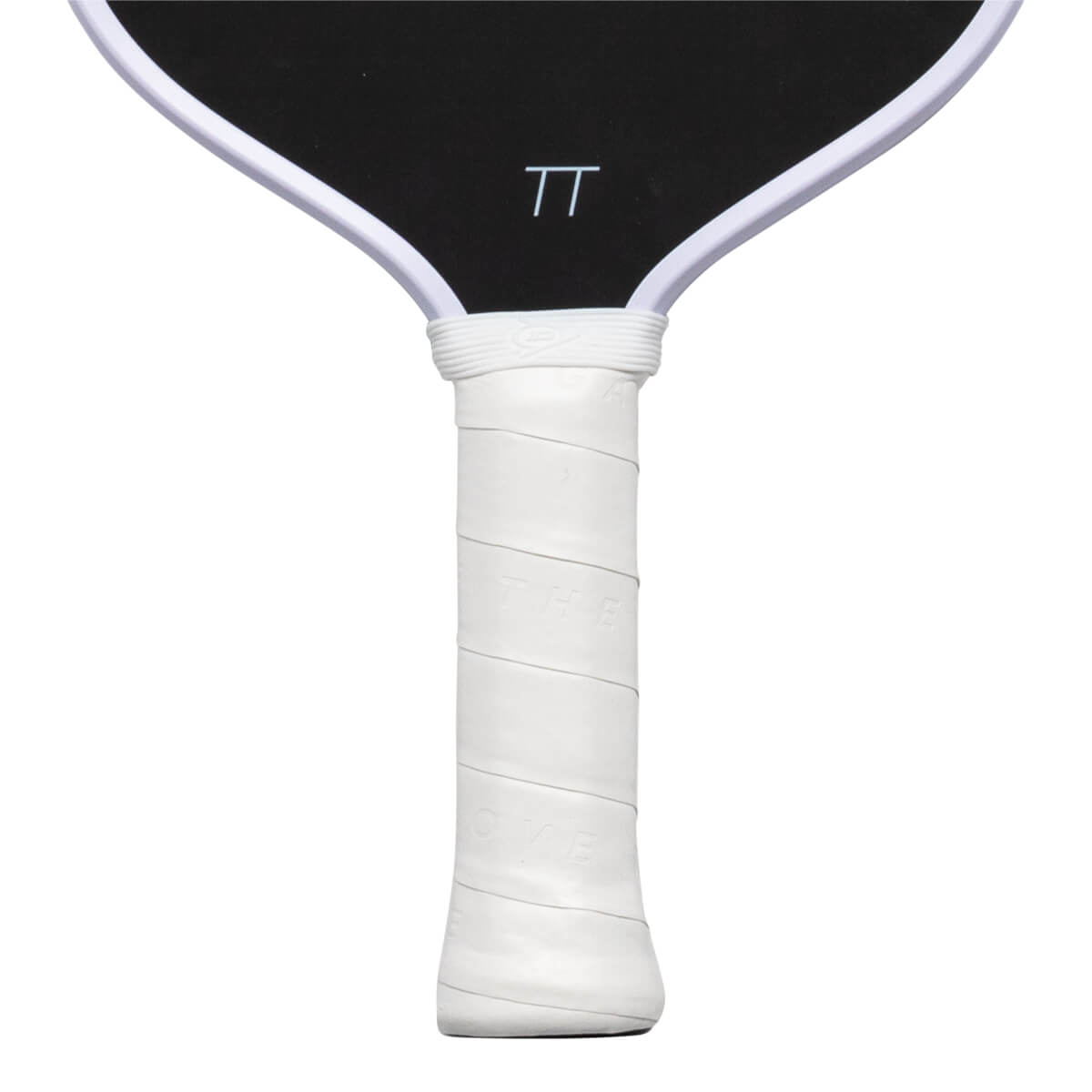 Close-up of the white wrapped handle with embossed "THE LOVE" text and the bottom of the black paddle face featuring a white "TT" logo.